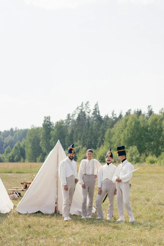 a group of men standing next to each other in a field, inspired by Wes Anderson, unsplash, renaissance, merchant tents, white uniform, finland, washington state