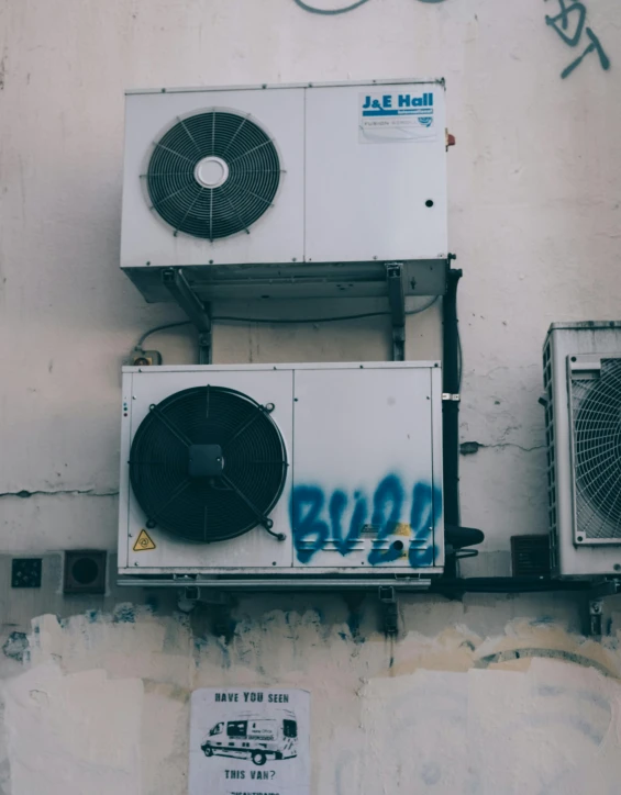 a couple of air conditioning units on the side of a building, a photo, pexels contest winner, graffiti, low quality photo, thumbnail, cute photo, cyberpunk photo