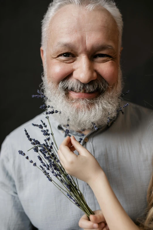 a man holding a bunch of flowers next to a little girl, a character portrait, by László Beszédes, trending on unsplash, silver hair and beard, lavender, made of dried flowers, portrait of bald