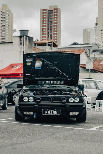 a black car is parked in a parking lot, by Manuel Franquelo, pexels contest winner, massive wide trunk, modded, sao paulo, frank franzzeta and sakimichan