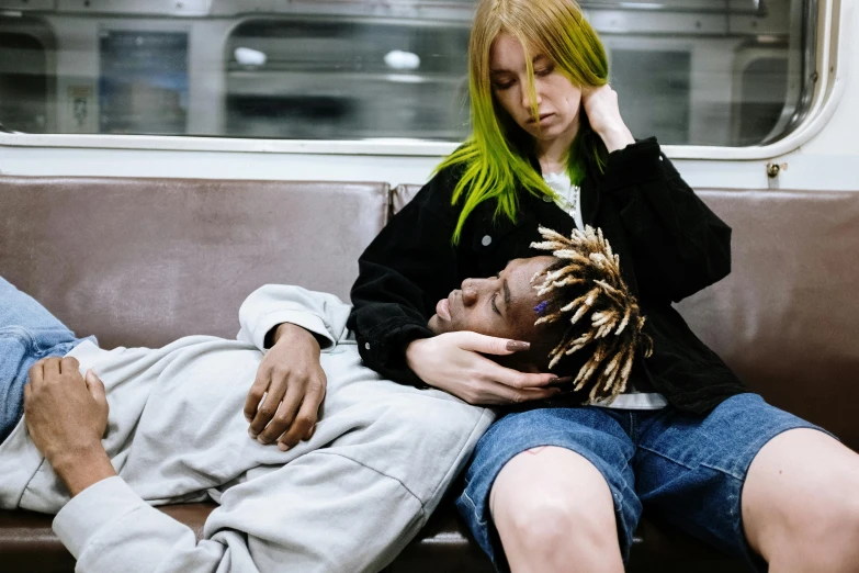 a man and a woman sitting next to each other on a train, inspired by Nan Goldin, trending on pexels, visual art, bright green hair, playboi carti and lil uzi vert, sleeping, embracing