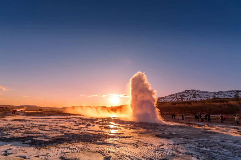 a geyser spewing water into the air at sunset, by Julia Pishtar, winter sun, epic land formations, exterior, high quality product image”