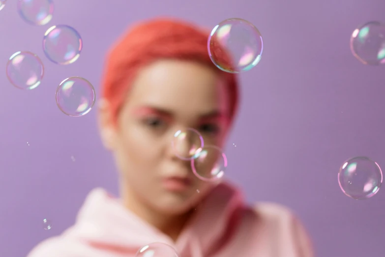 a woman in a pink hoodie blowing bubbles, inspired by Yanjun Cheng, trending on pexels, magic realism, lilac hair, studio shoot, animation, blur effect