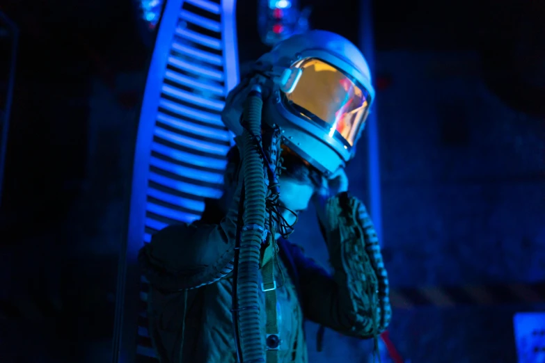 a close up of a person wearing a helmet and goggles, cyberpunk art, by Adam Marczyński, pexels contest winner, standing in a starbase bar, lunar themed attire, wearing human air force jumpsuit, instagram post