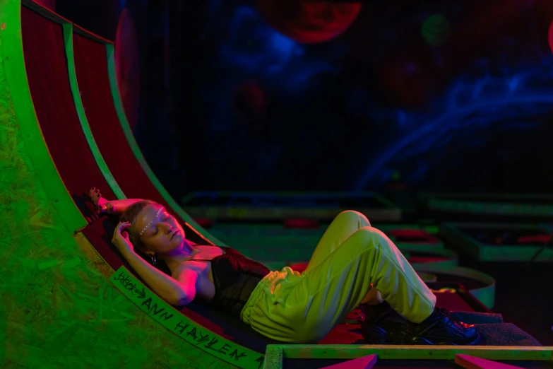 a woman that is laying down in a hammock, inspired by Gustave Boulanger, maximalism, neon basement, softplay, green neon, outer space