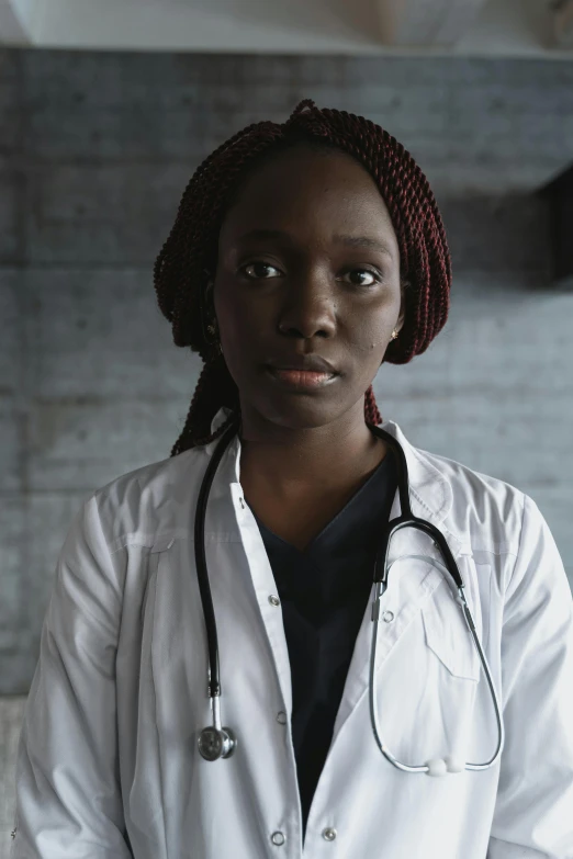 a woman in a lab coat with a stethoscope, inspired by Dr. Atl, adut akech, black teenage girl, 2019 trending photo, looking serious