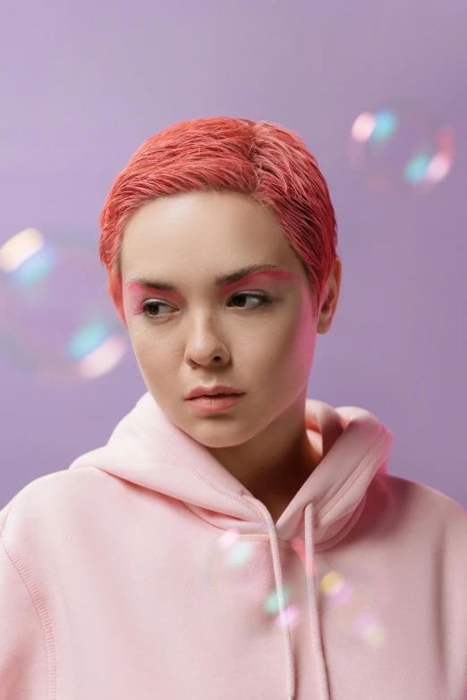 a woman with red hair wearing a pink hoodie, inspired by Yanjun Cheng, trending on pexels, short blue haired woman, non binary model, ryan glitter concept artist, pixie cut