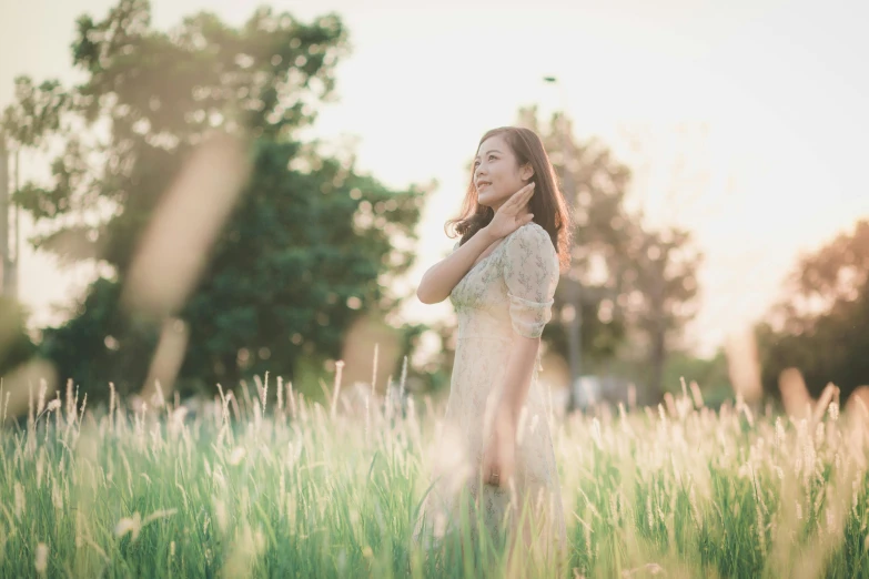 a woman standing in a field of tall grass, by Tan Ting-pho, unsplash, medium format. soft light, spring evening, soft light - n 9, sunny afternoon