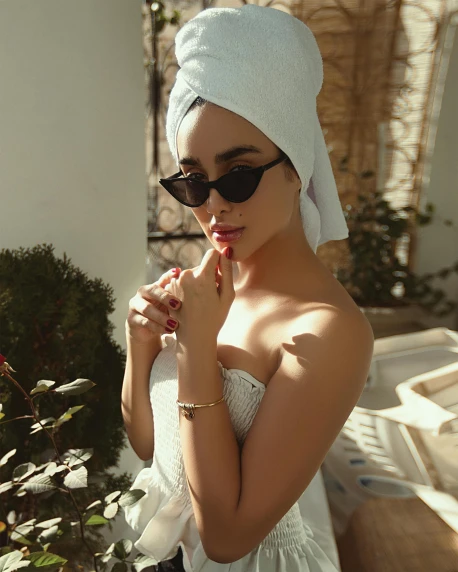 a woman with a towel wrapped around her head, a colorized photo, inspired by Hedi Xandt, trending on pexels, sunglasses, madison beer, elegant sleek smooth body, nice afternoon lighting