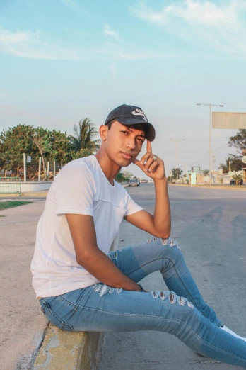 a man sitting on a curb talking on a cell phone, a picture, by Sebastian Vrancx, instagram, wearing a shirt and a jean, joseph moncada, album photo, headshot profile picture