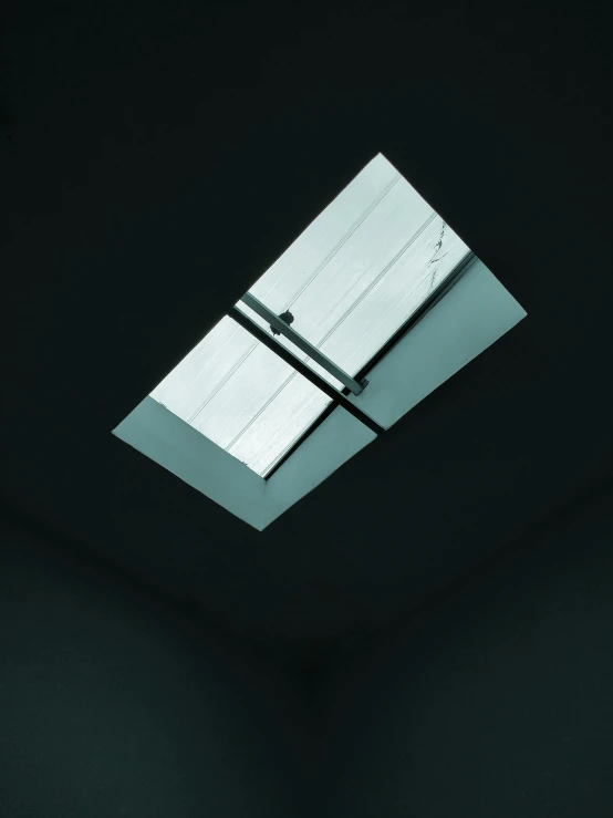 a white toilet sitting under a skylight in a bathroom, an album cover, inspired by Donald Judd, unsplash, light and space, black roof, view from below, metal, high-angle