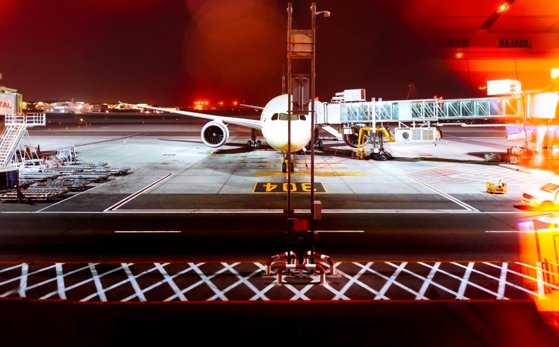 a large jetliner sitting on top of an airport tarmac, by Daniel Lieske, pexels contest winner, vivid lights, rectangle, full frame image, thumbnail