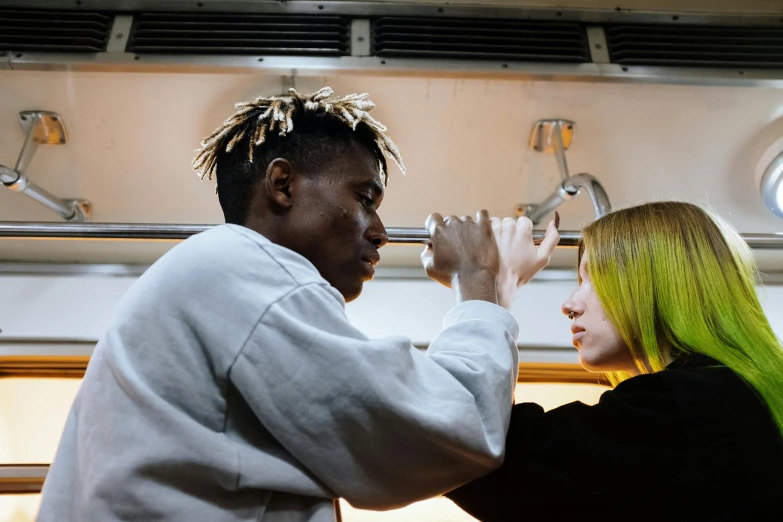 a man and a woman standing next to each other, trending on pexels, visual art, dreadlock hair, in a workshop, playboi carti, a blond