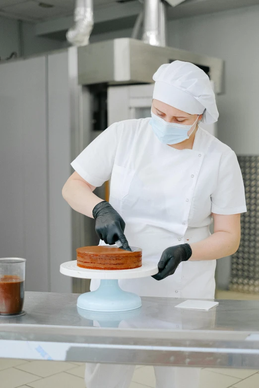 a woman in a kitchen preparing a cake, on a advanced lab, finely masked, perfectly poised, healthcare worker