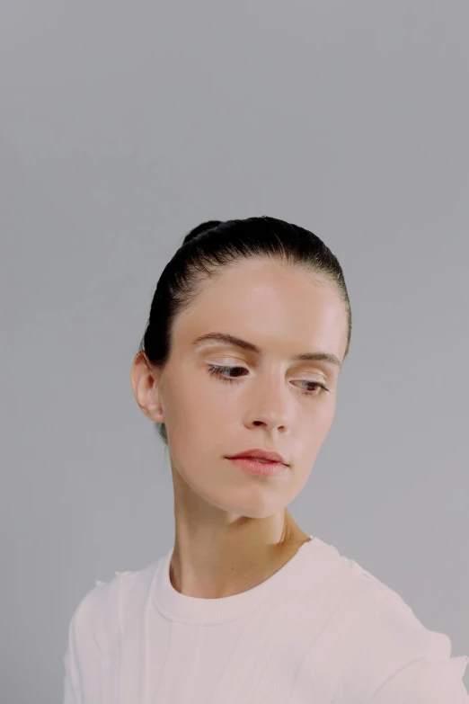 a woman in a white shirt posing for a picture, slicked-back hair, video still, highly reflective surface, natural make-up