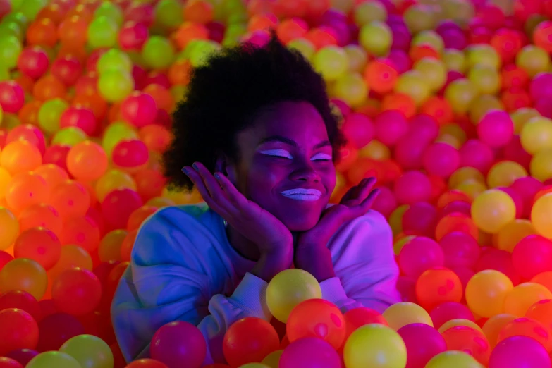 an image of a woman in a ball pit, inspired by David LaChapelle, pexels contest winner, interactive art, neon glowing eyes, ( ( dark skin ) ), cheerful ambient lighting, instagram photo