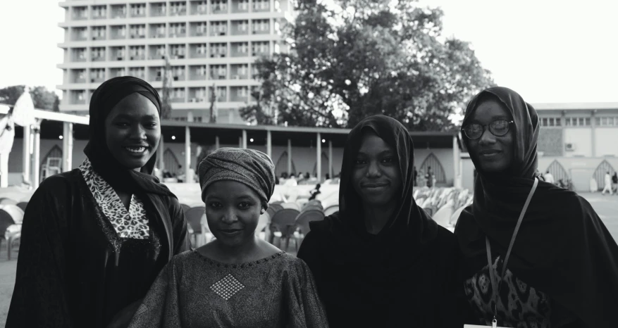 a group of women standing next to each other, a black and white photo, by Chinwe Chukwuogo-Roy, unsplash, hurufiyya, muslim, post graduate, inauguration, portrait of a beautiful