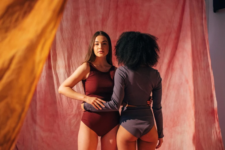 a couple of women standing next to each other, by Nina Hamnett, unsplash contest winner, renaissance, wearing leotard, maroon, colour blocking, photoshoot for skincare brand