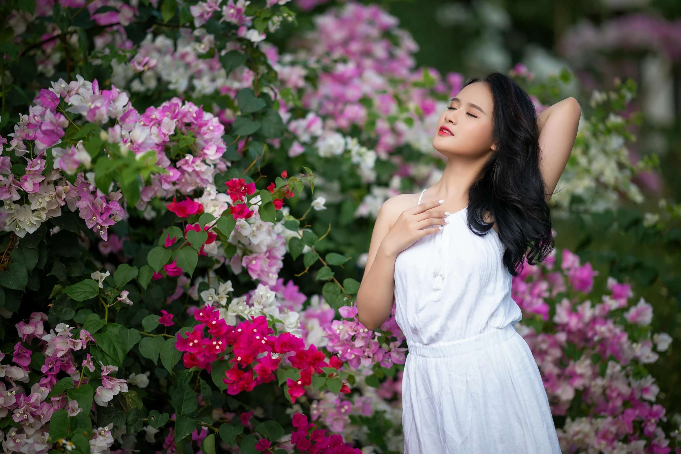a woman standing in front of a bunch of flowers, pexels contest winner, beautiful asian woman, white and pink, paradise garden massage, doing an elegant pose