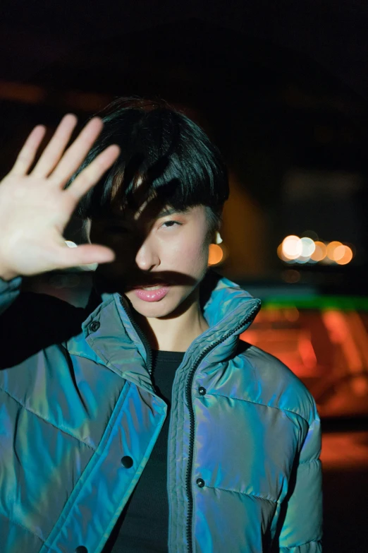 a close up of a person wearing a jacket, inspired by Zhu Da, unsplash, holography, waving at the camera, light over boy, asian human, promo image