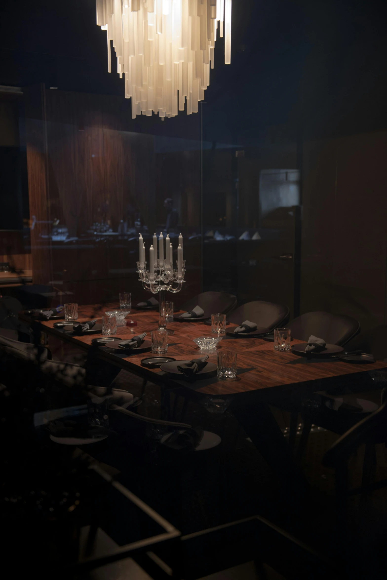 a dining room table with a chandelier hanging from the ceiling, by Jesper Knudsen, renaissance, pitch dark room, chef table, full room view, todd hido