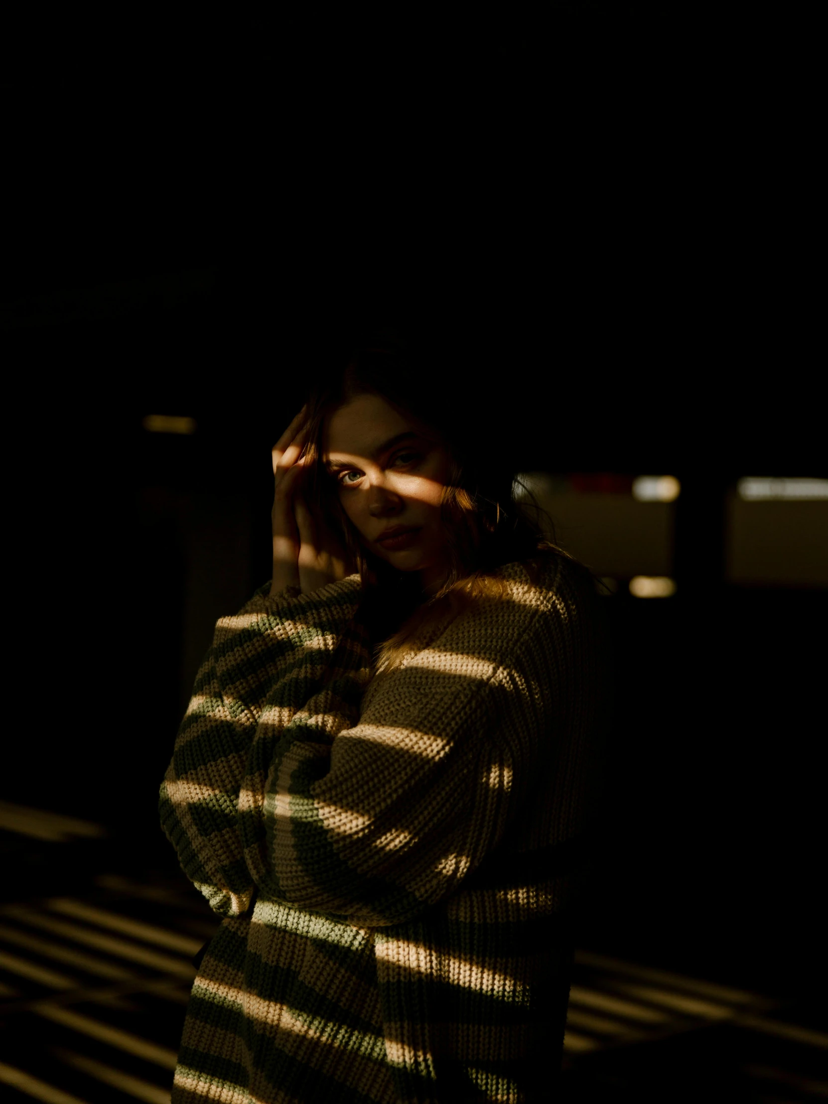 a woman standing in the dark with her hands on her face, inspired by Elsa Bleda, unsplash, soft shadow, low quality photo, instagram post, cinematic shot ar 9:16 -n 6 -g