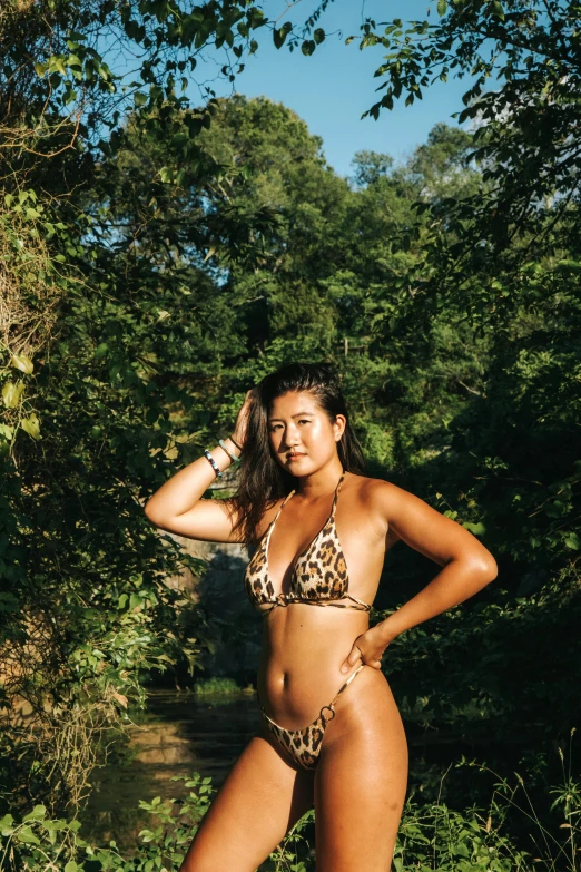a woman in a leopard print bikini posing for a picture, by Sven Erixson, unsplash, laos, slightly tanned, in full growth, gemma chen