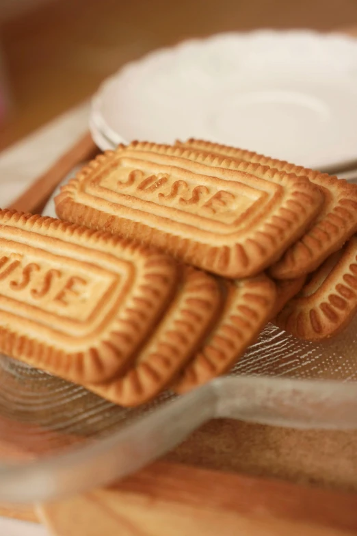 a close up of a plate of cookies on a table, by Yasushi Sugiyama, rasquache, garis edelweiss, swedish writing, 6 pack, cream