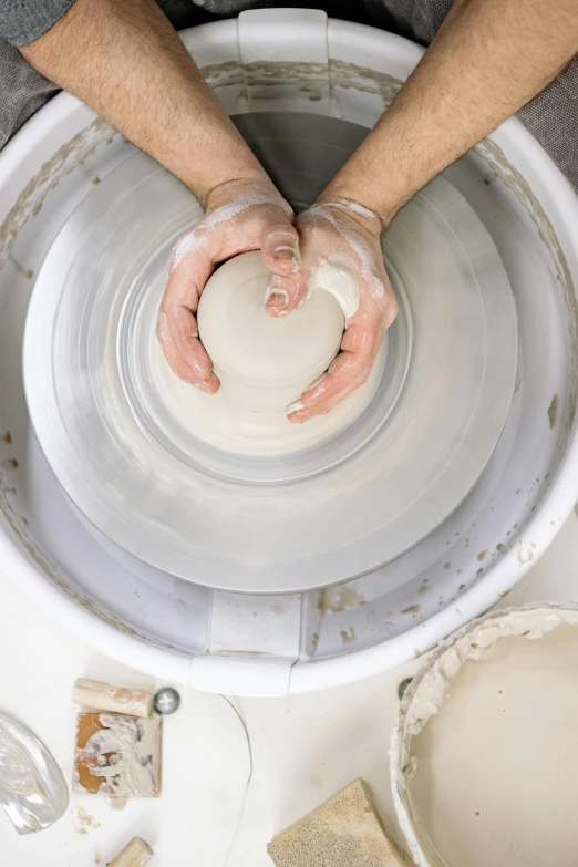 a person making a bowl on a potter's wheel, a marble sculpture, inspired by Hendrik Gerritsz Pot, white, 8 l, promo image, medium detail