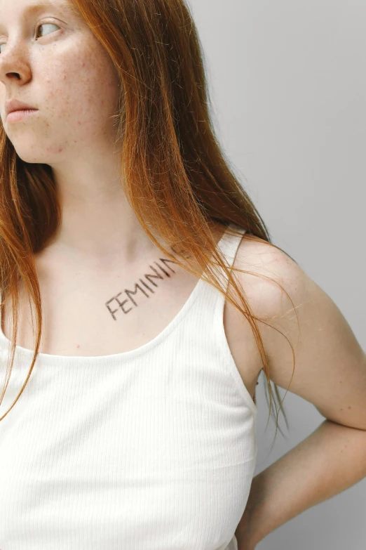 a woman with a tattoo on her chest, inspired by Hannah Frank, trending on pexels, feminist art, sadie sink, in white lettering, permanent marker, extremely pale
