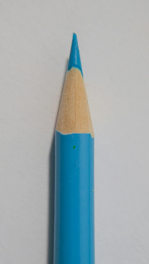 a blue pencil sitting on top of a white surface, a photorealistic painting, inspired by Gerard David, unsplash, hyperrealism, dayglo blue, wikimedia, smurf, detailed color scan