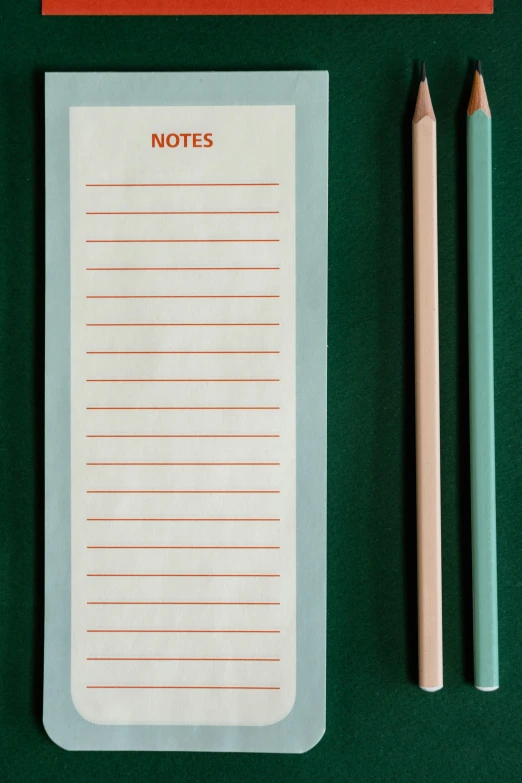 a notepad sitting on top of a desk next to two pencils, by David Simpson, teal and orange colors, graphic detail, hay, green