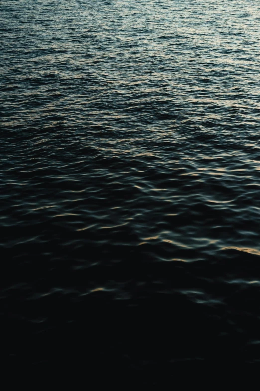 a man riding a surfboard on top of a body of water, an album cover, inspired by Elsa Bleda, unsplash, dark ocean water, ignant, honey ripples, calm evening