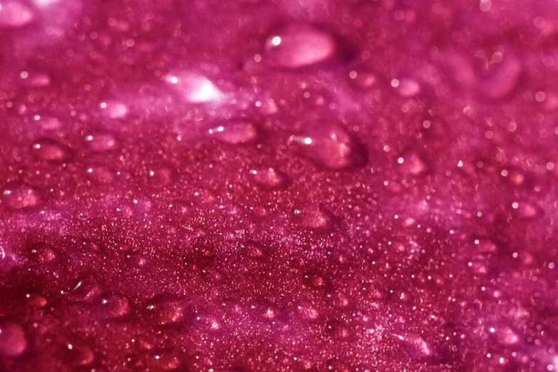 a close up of water droplets on a purple surface, a macro photograph, by Gina Pellón, pexels, process art, rich deep pink, glitter gif, 4 k hd wallpapear, raspberry