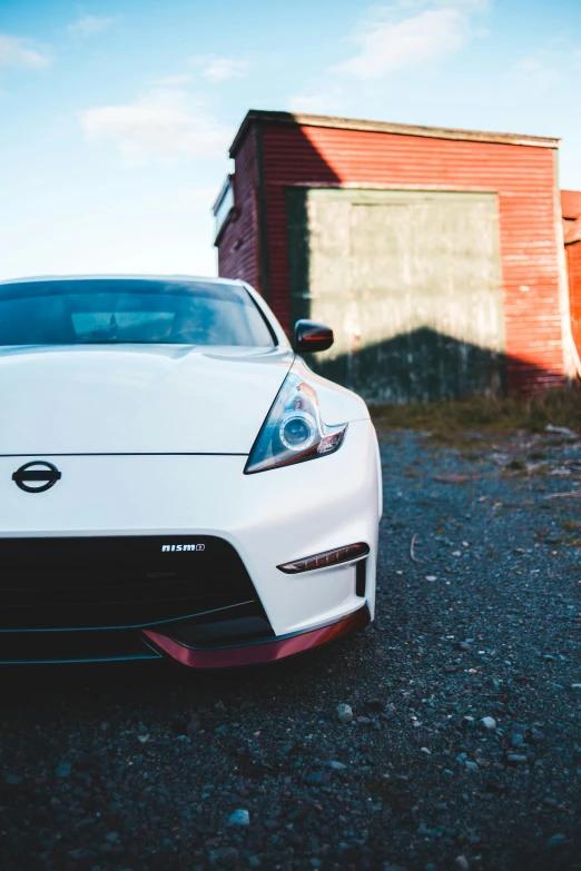 a white sports car parked in front of a building, by Matt Cavotta, pexels contest winner, square, white red, jdm, front lit