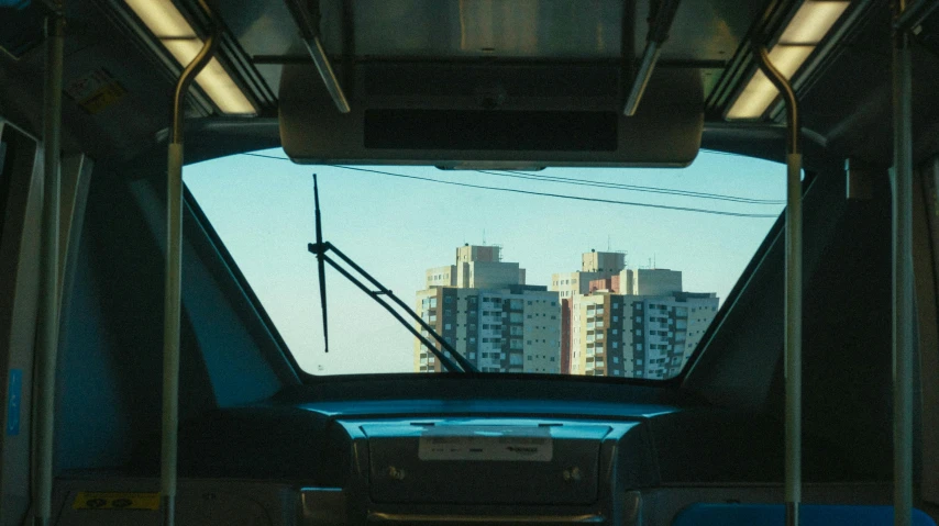 a view of a city from the inside of a bus, an album cover, inspired by Elsa Bleda, unsplash, hyperrealism, still from a wes anderson film, azamat khairov, trains, blue sky