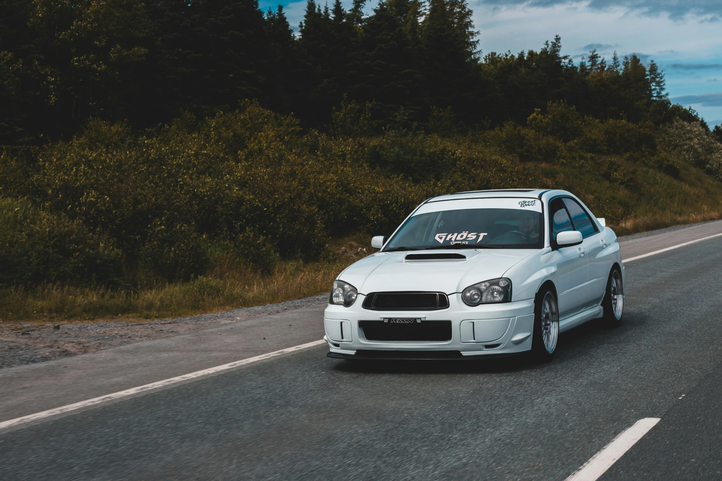 a white car driving down a road next to a forest, inspired by Michael Gustavius Payne, unsplash, graffiti, subaru, 000 — википедия, on a racetrack, quebec