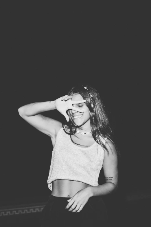 a black and white photo of a woman in a crop top, happening, smiley, selenar, hands down, (night)