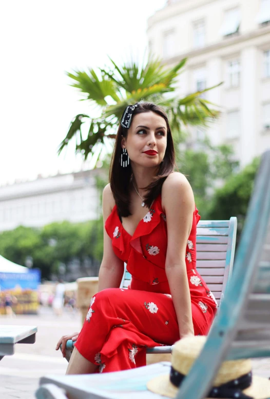 a woman in a red dress sitting on a bench, photo of džesika devic, influencer, wearing a camisole, avatar image