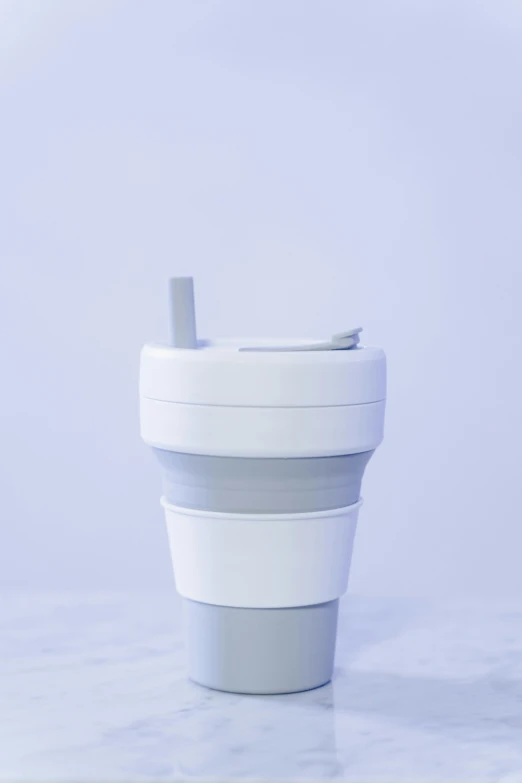 a close up of a cup on a table, product image, folded, light grey, silicone skin