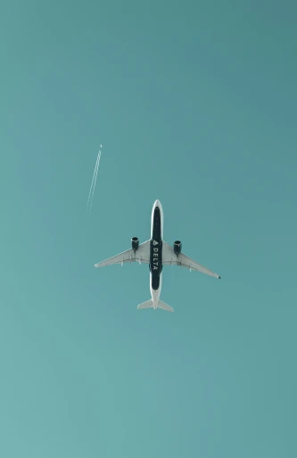 a large jetliner flying through a blue sky, a picture, by Will Ellis, pexels contest winner, minimalism, spores floating in the air, teal aesthetic, 1 4 9 3, plain background
