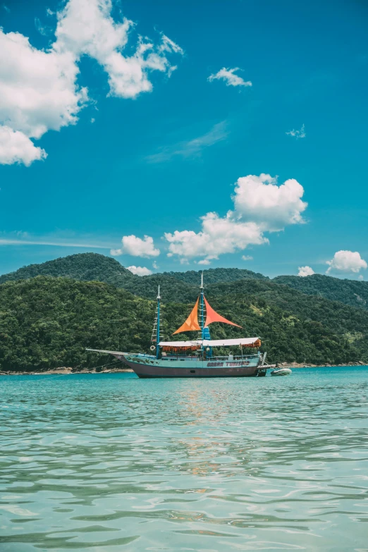 a boat floating on top of a body of water, on a pirate ship, lush surroundings, in hong kong, teal orange