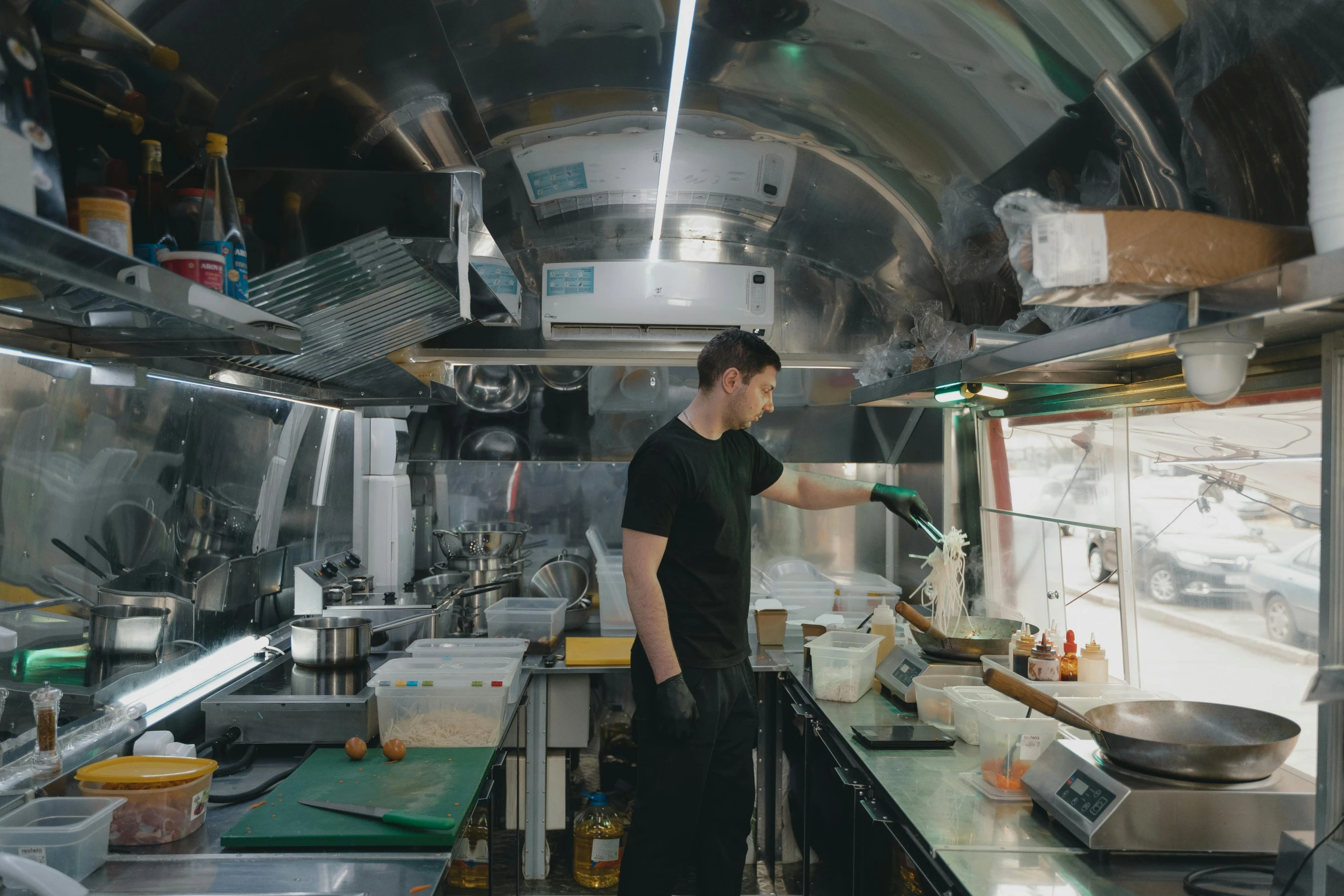 a man standing in a kitchen preparing food, unsplash, art nouveau, trailer, aussie baristas, built on a small, ignant