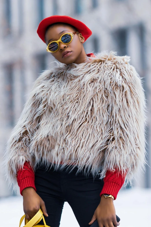 a woman wearing a furry coat and holding a yellow bag, trending on pexels, visual art, brown skinned, beret and sunglasses, wearing red fur cloak, trending on textures. com