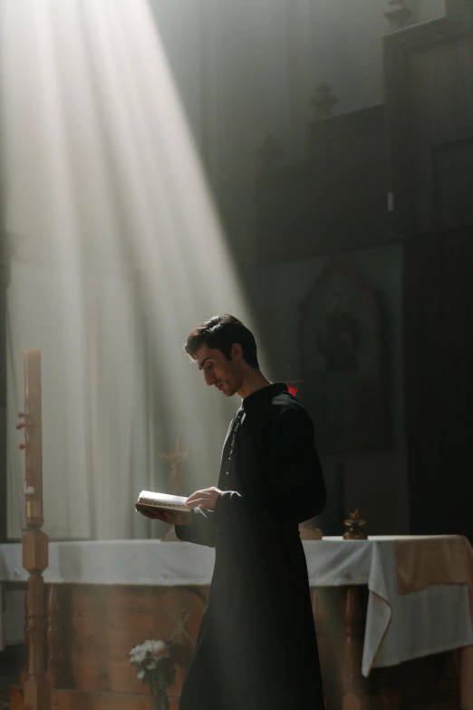 a priest reading a book in a church, unsplash, romanticism, standing under a beam of light, film still of ryan reynolds, ignant, male with halo