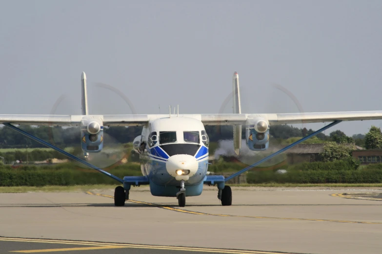 a blue and white plane sitting on top of an airport runway, nezha, in formation, portrait n - 9, csok istvan