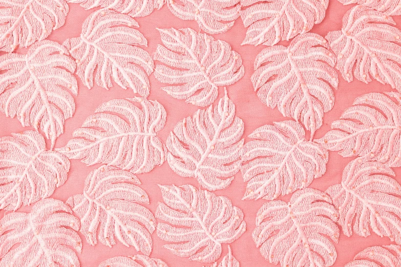 a pink fabric with white leaves on it, inspired by Master of the Embroidered Foliage, trending on pexels, palm skin, textured base ; product photos, brightly lit, 3 4 5 3 1