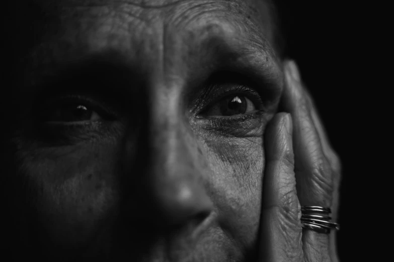 a close up of a person holding their hands to their face, a black and white photo, by Kristian Zahrtmann, pexels, hyperrealism, portrait of a old, portrait of a sharp eyed, portrait of rugged adult female, portrait!!!!