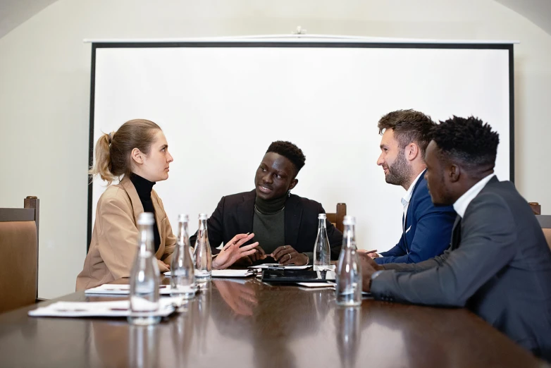 a group of people sitting around a conference table, black man, slightly minimal, high-quality photo, thumbnail