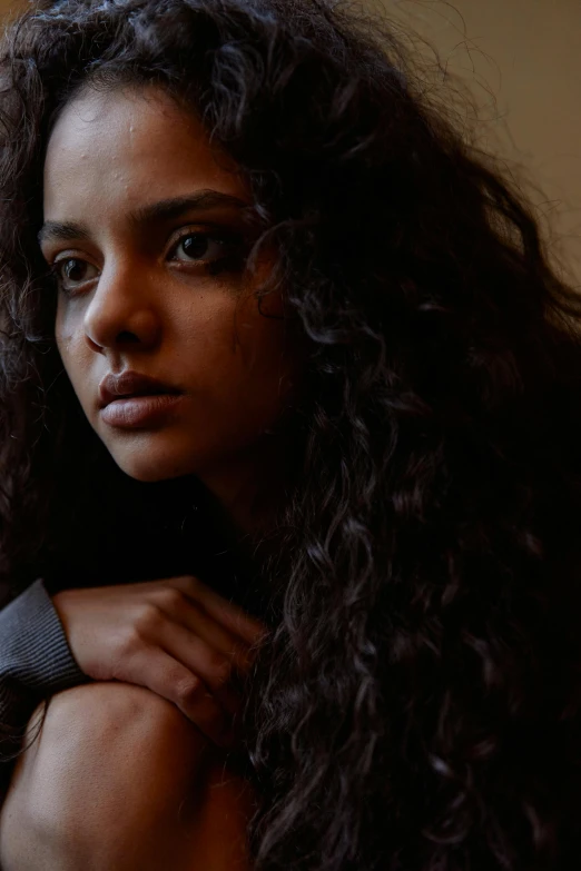 a close up of a person with long hair, trending on unsplash, tessa thompson inspired, portrait of depressed teen, imaan hammam, dafne keen